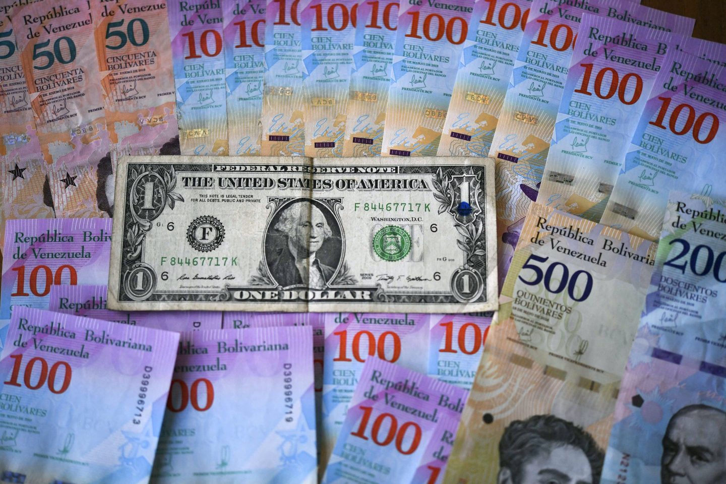 Venezuelan flag beside US dollar bills