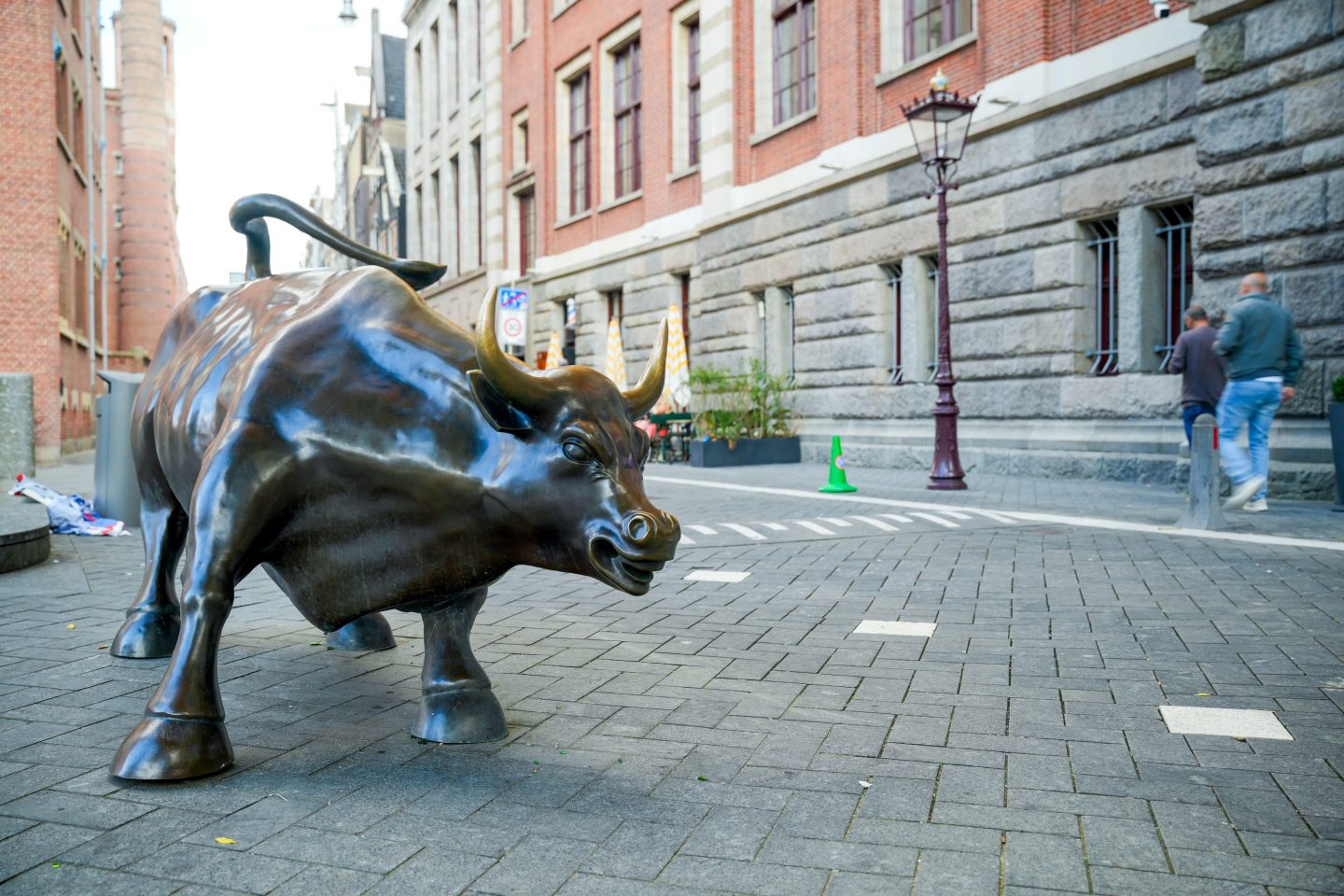 Trading screens showing European stock index charts with green upward arrows