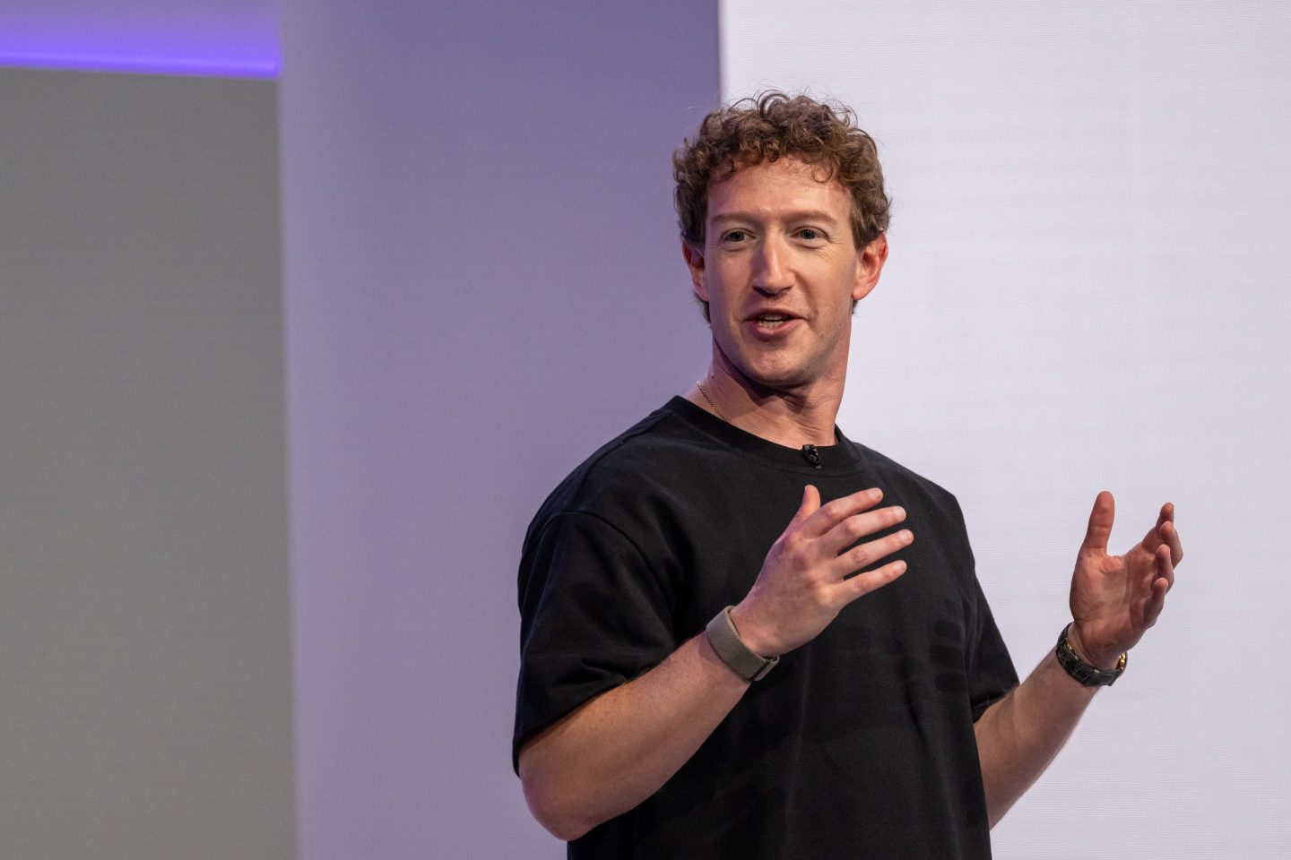 Mark Zuckerberg speaking at a conference with AI graphics