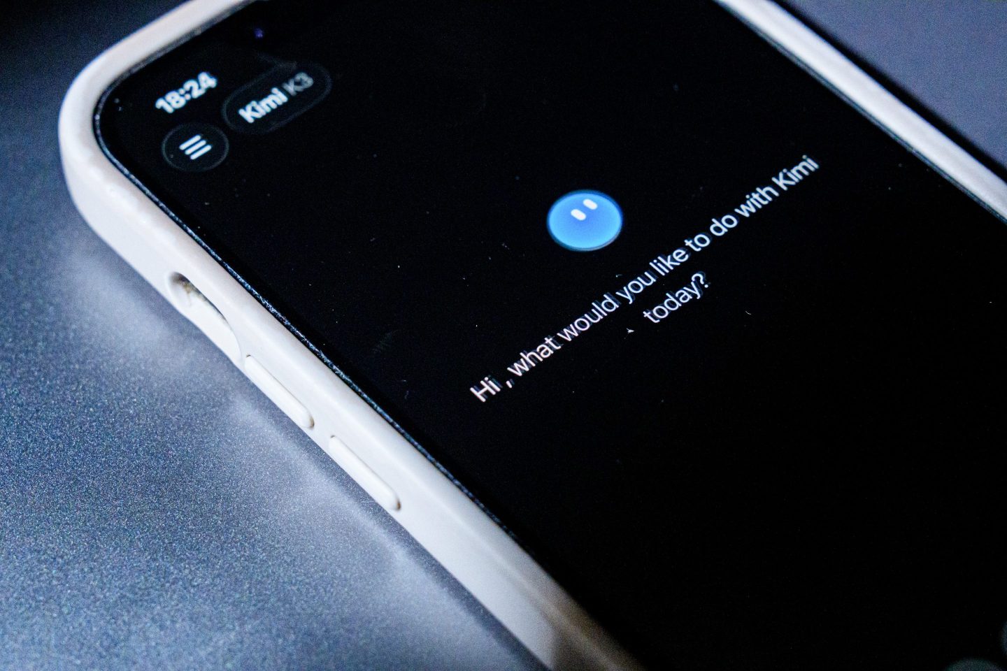 Person typing on a smartphone while looking thoughtful, representing AI chatbot conversation