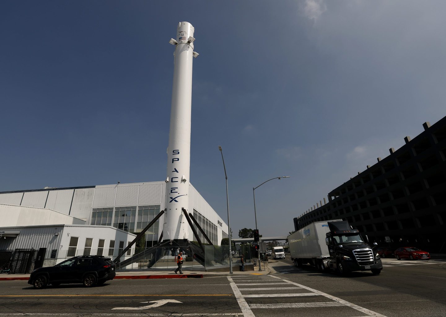 SpaceX Starship rocket on launch pad with a backdrop of a gas power plant