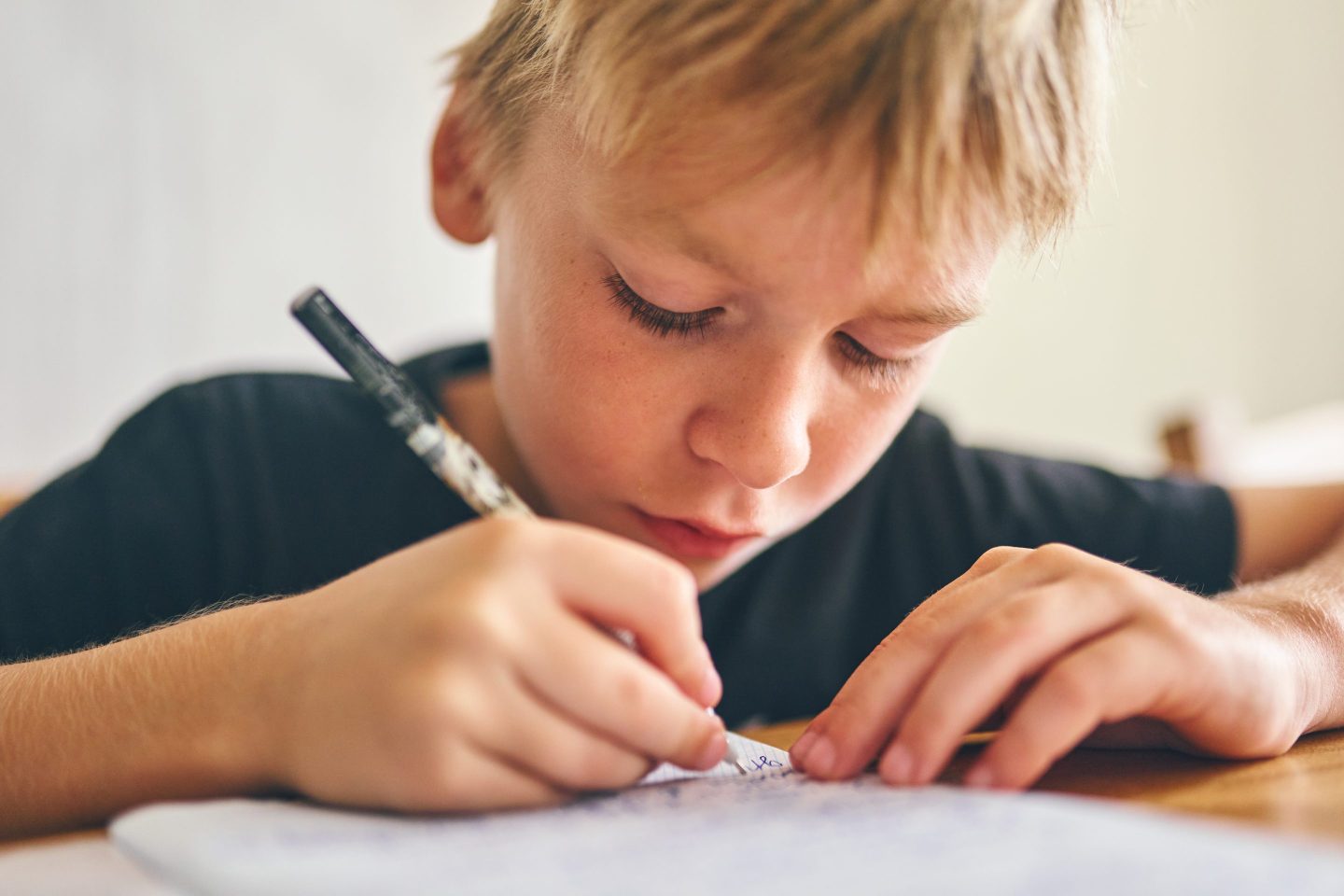 Students practicing cursive writing in a classroom