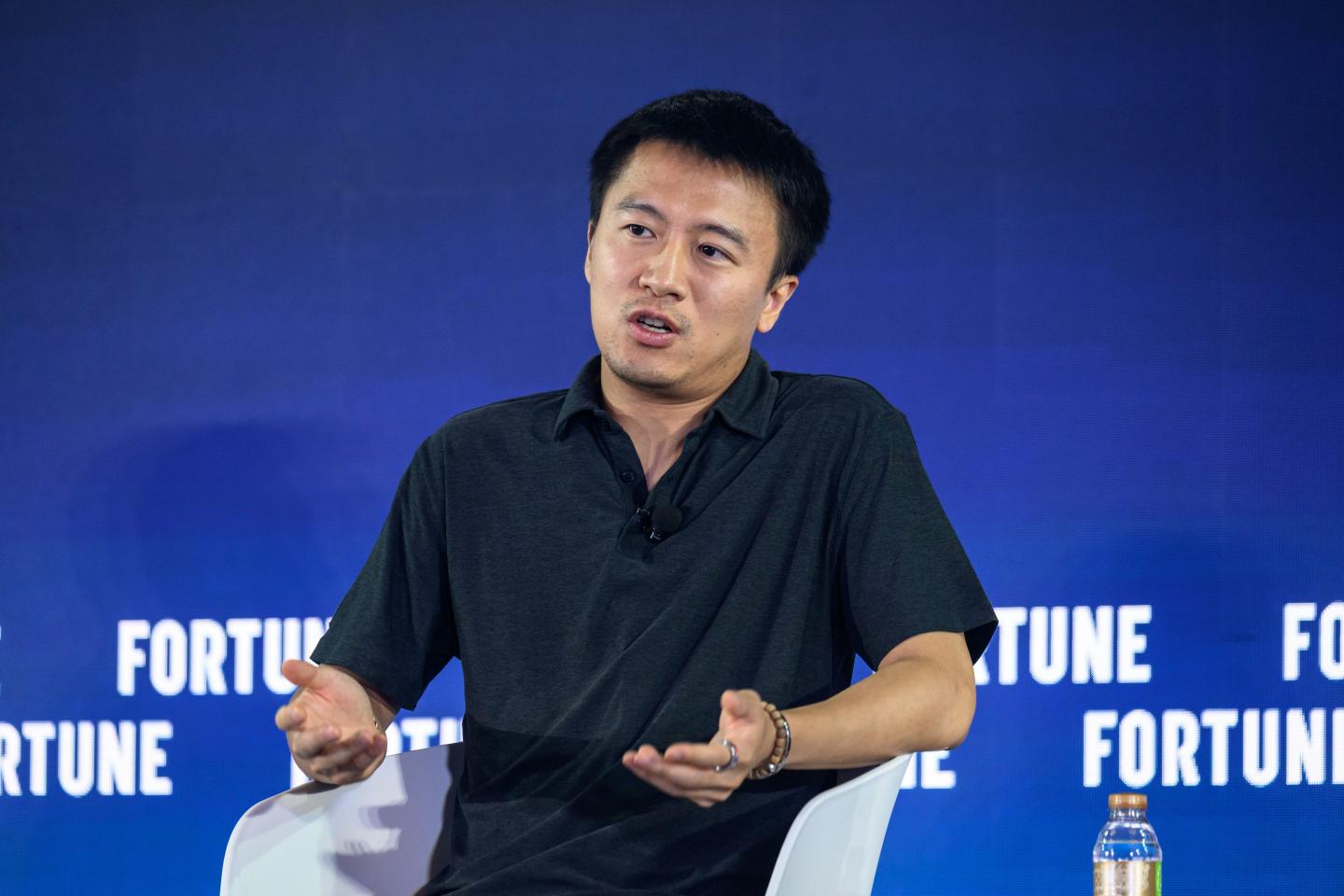 Yuxiang Zhou demonstrating AI sales coach on a digital tablet