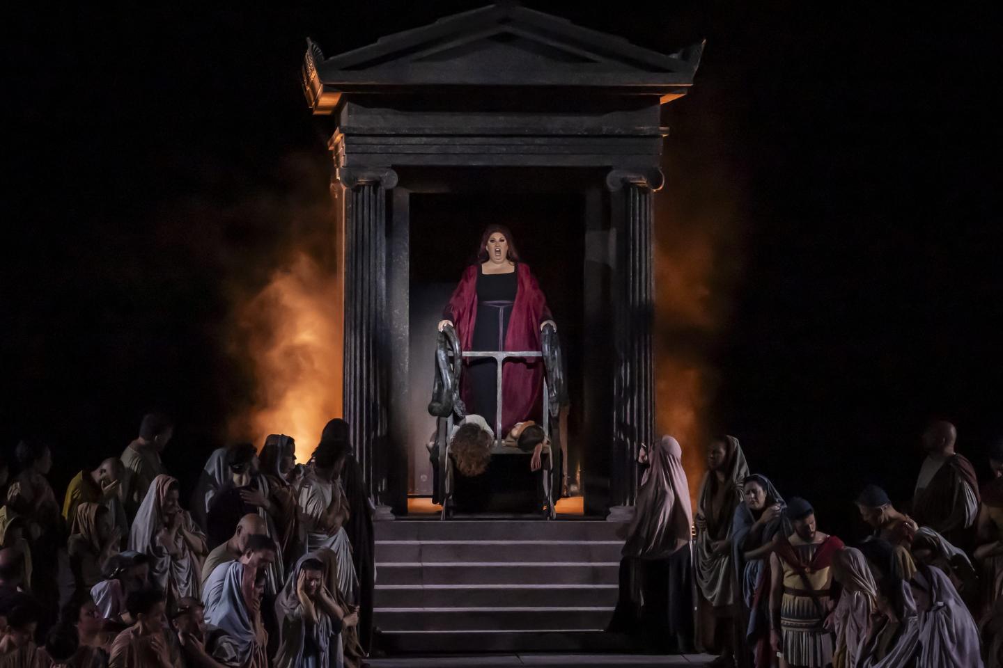Ancient Greek tablet beside a modern laptop displaying AI text